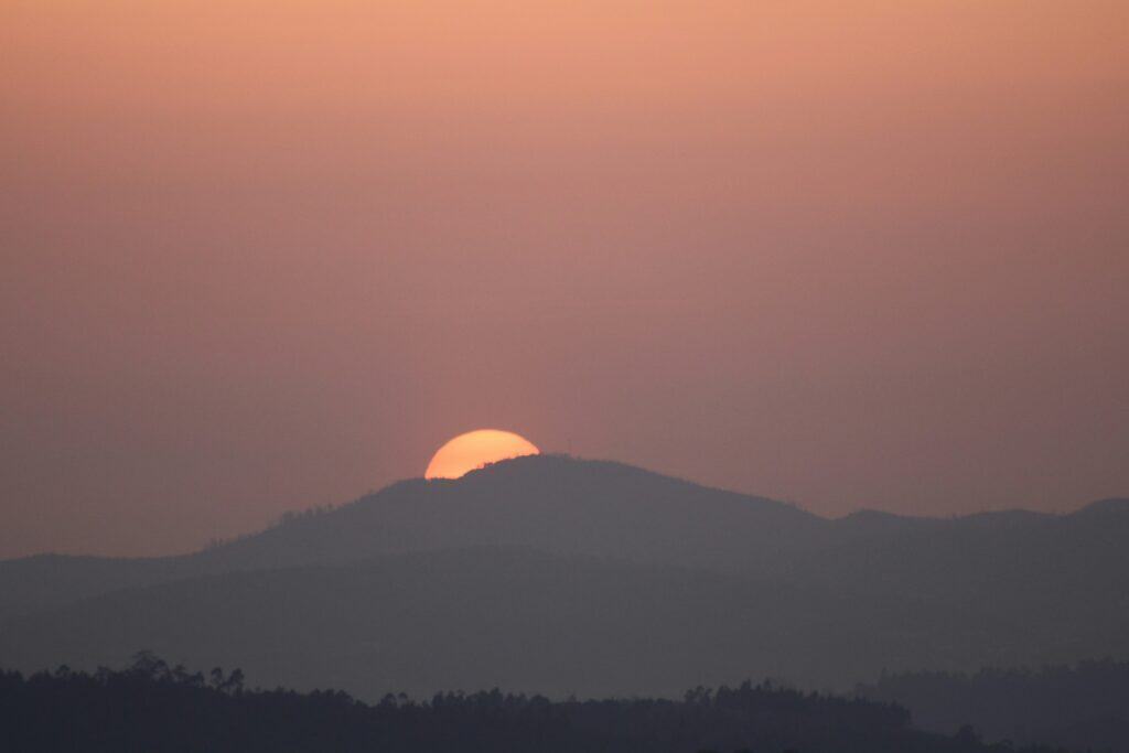 sun going down over mountain