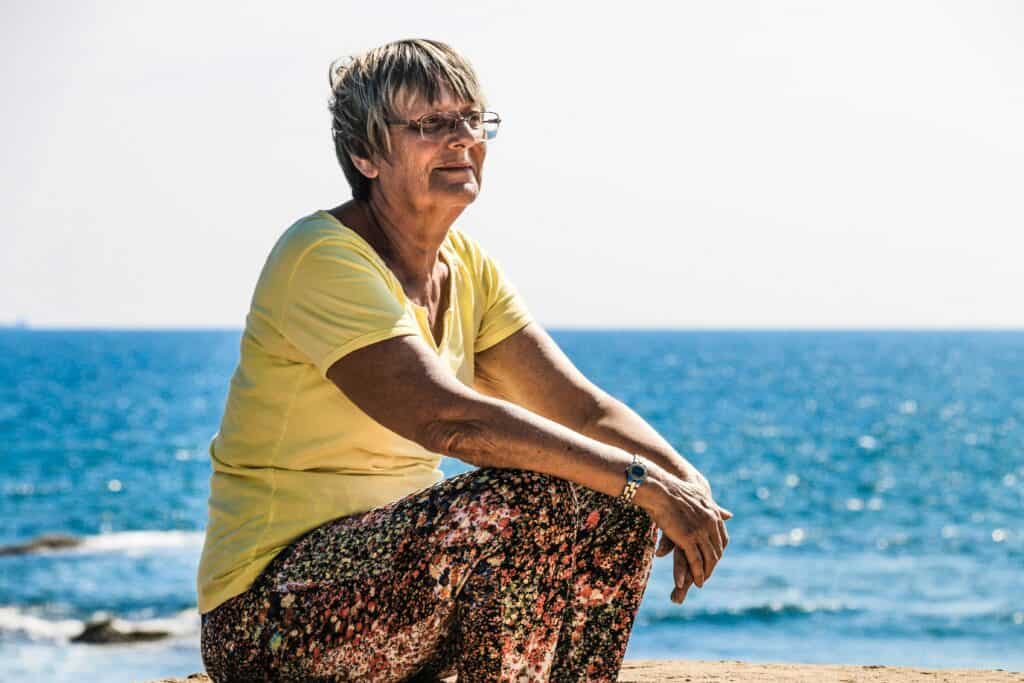 older woman by beach