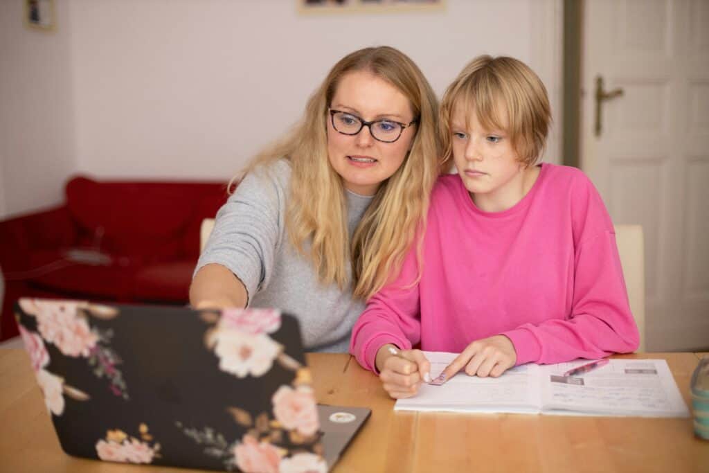 mom and teen daughter on computer