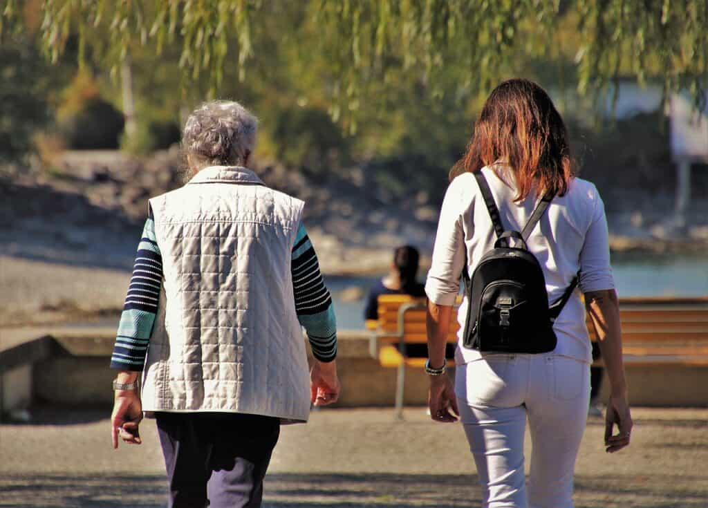 younger woman and older woman walking together