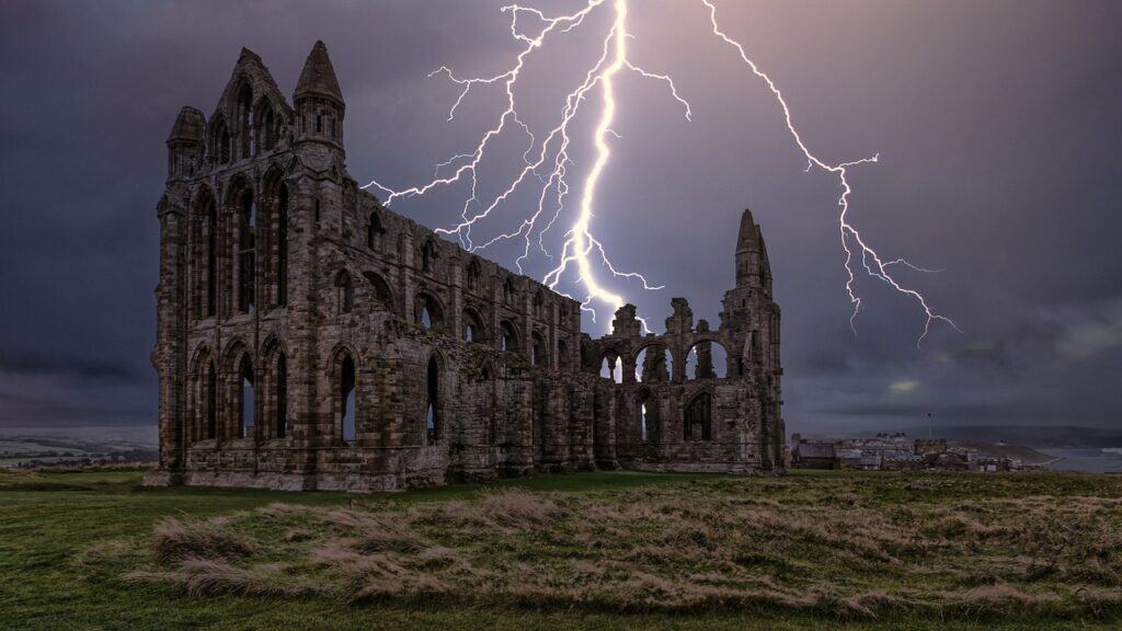 old abbey ruins with lightening striking