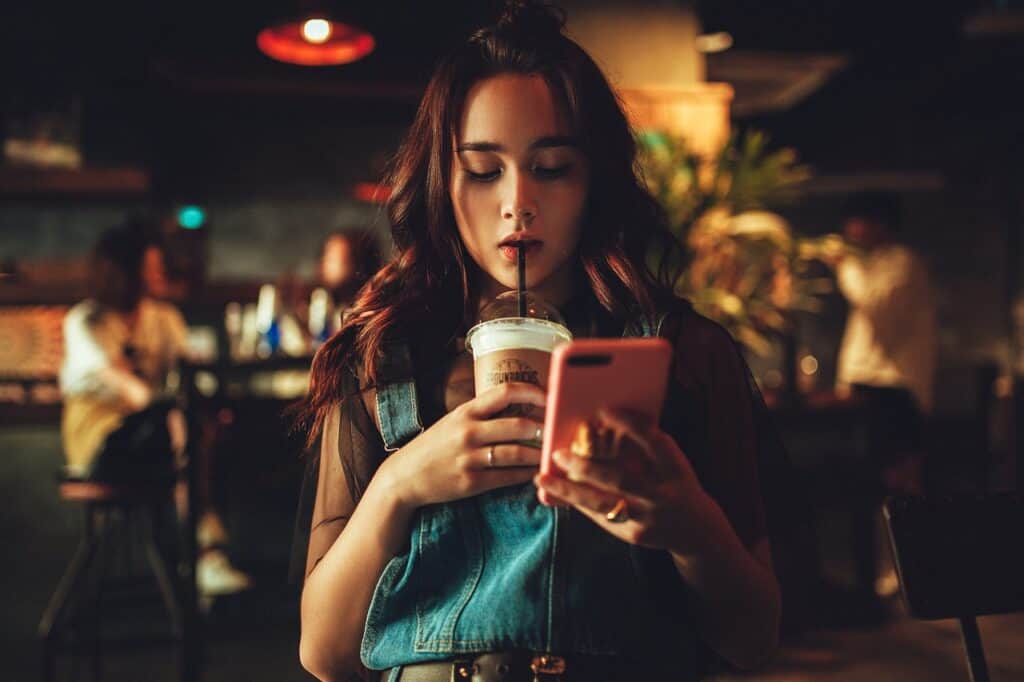 girl drinking coffee on cell phone