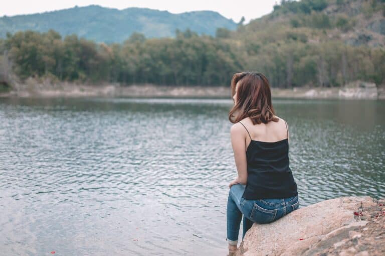 woman back to camera facing lake