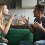 A young husband and wife argue on a couch. Here's a a practical process of healthy conflict resolution in marriage.