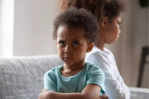 Emotionally turbulent siblings frequently are upset with one another like these sisters with arms crossed and frowns