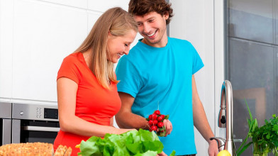 Married couple in kitchen preparing a meal together