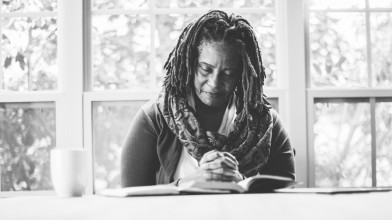 Woman praying over a Bible