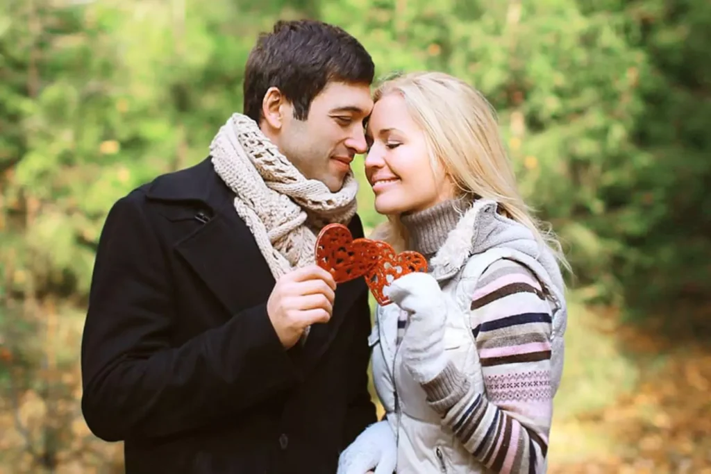 Husband and wife holding 2 hearts in their hands