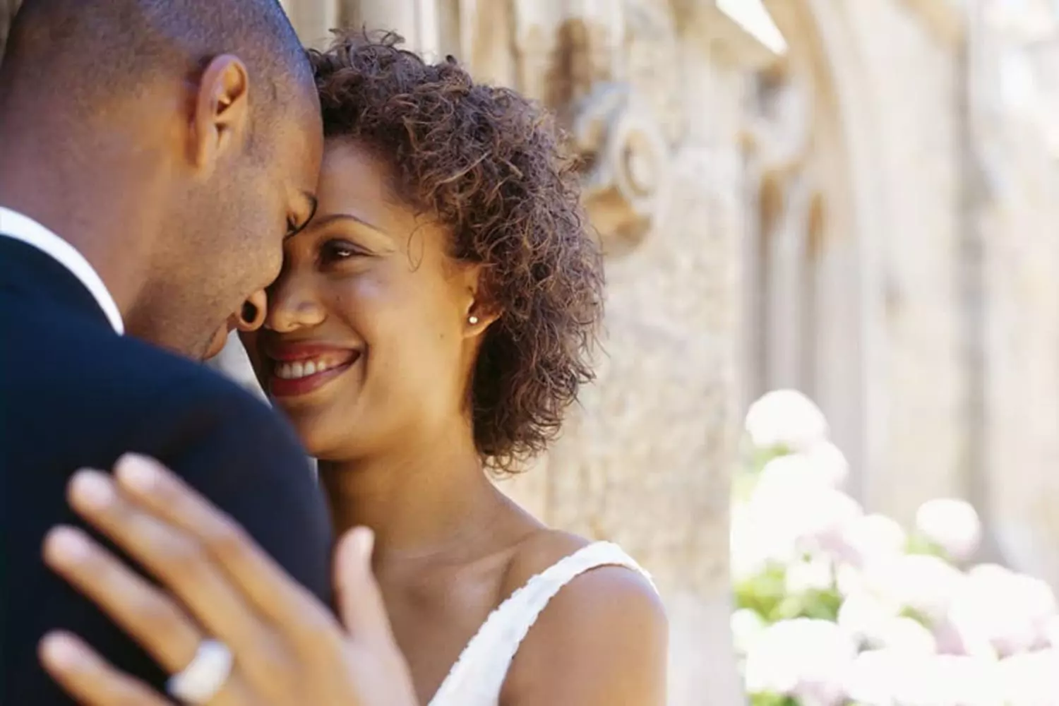 A newlywed couple embraces closely, symbolizing marriage expectations of love, connection, and mutual happiness.