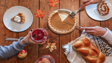 A family serves Thanksgiving dinner