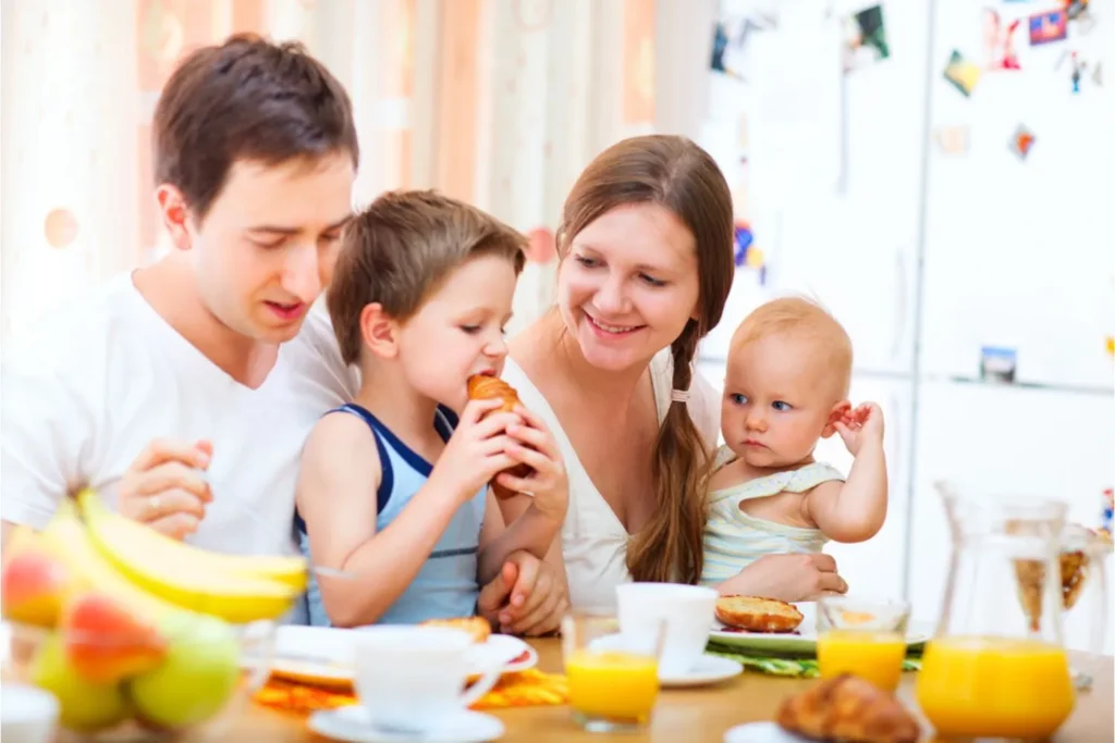 Dad, mom, and two young children at the breakfast table