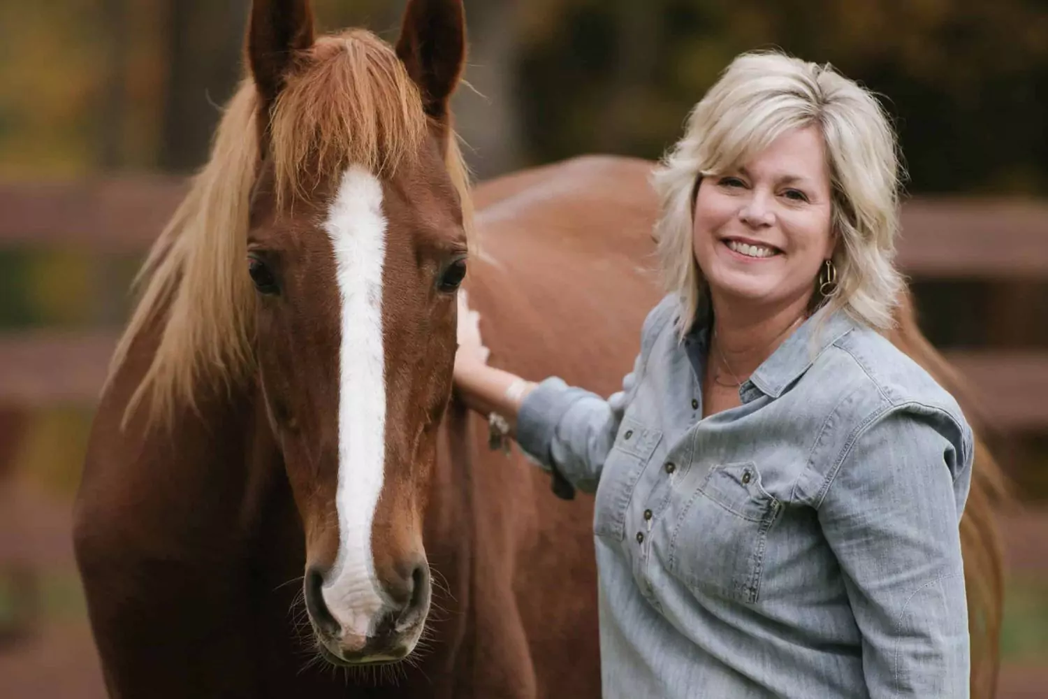 Photo of Kim Tscherrit with an abused horse from her ministry Hope Reigns, supported by her spouse Mike.