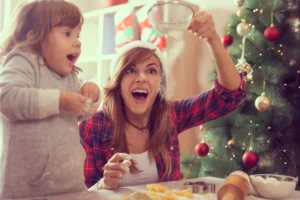 making cookies with mommy. Little girl and her mom excited making cookies together