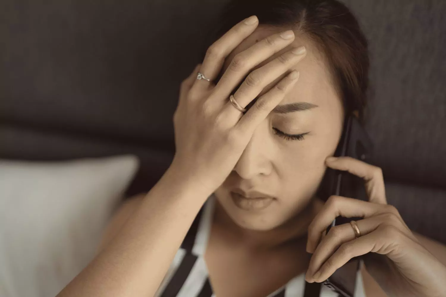 Asian woman crying on the phone