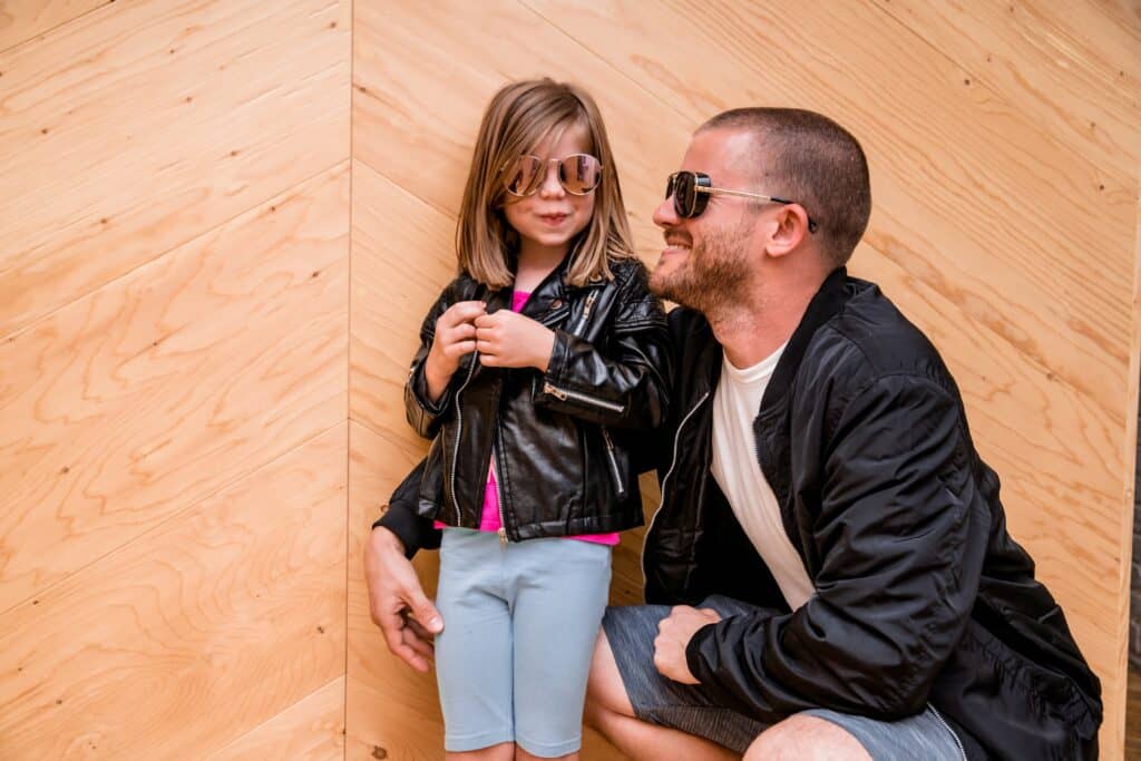 Dad and daughter posing in sunglasses