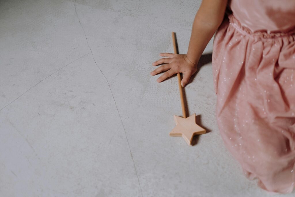 edge of pink dress with fairy wand