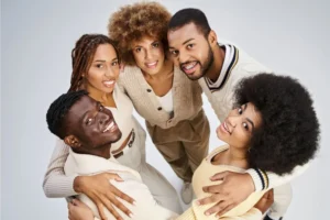 Five young adults in a circle looking up and celebrating happy Juneteenth