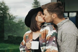 A couple shares a sweet kiss, capturing one of the relationship rituals that help you stay connected to your spouse.