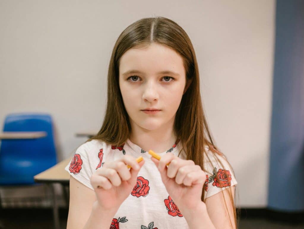 defiant girl who just broke her pencil