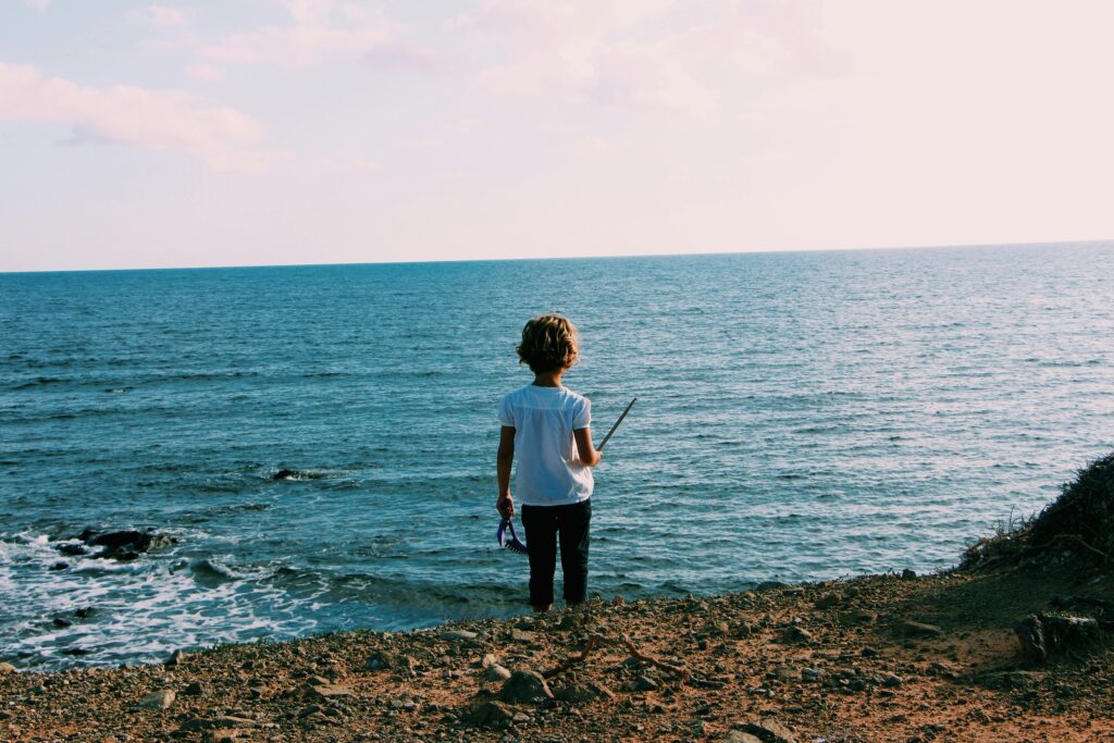 child looking at ocean