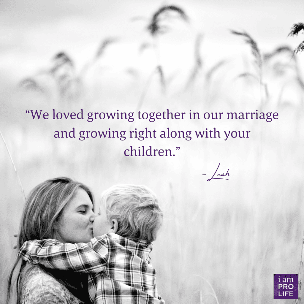 A white image of a mother holding and kissing her child in a field with the caption: We loved growing together in our marriage and growing right along with your children. - Leah