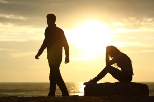 A silhouette of a man and a woman at sunset. The man is walking away from the woman as the woman sits with her head in her hands. Marriage struggles are normal. Often, couples ask, "Is divorce the right answer?" These 15 questions will help you evaluate your marriage.