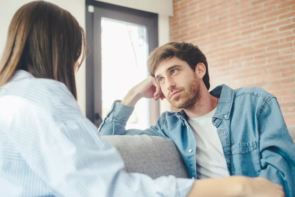 A photo of a young couple sitting on the couch, facing each other. You can see the back of the woman, and the man is facing her, listening intently. If there's one thing I have been working on in my marriage, it's this need reconnect with my spouse through meaningful conversation.