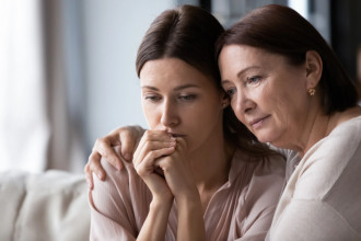 Mom comforting her worried grown daughter