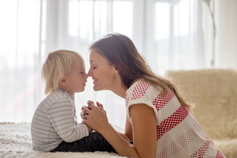 Mother praying with her young child, demonstrating faith and prayer in parenting.