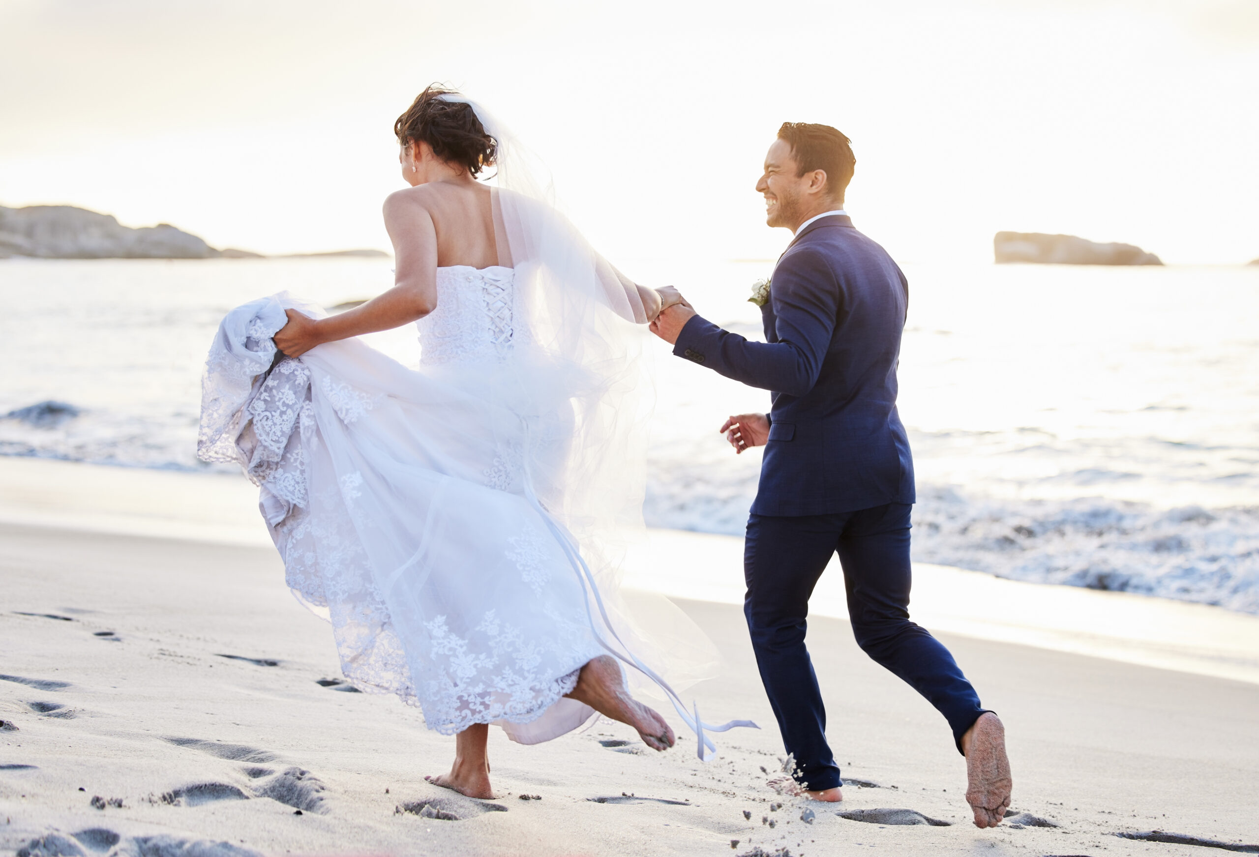 Shot of a young couple on the beach during their wedding day.