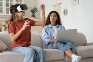 Girl using Virtual reality with her mother watching sitting on the couch next to her