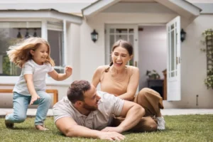 Family laughing and playing together in their backyard, illustrating the importance of family time and building strong relationships.