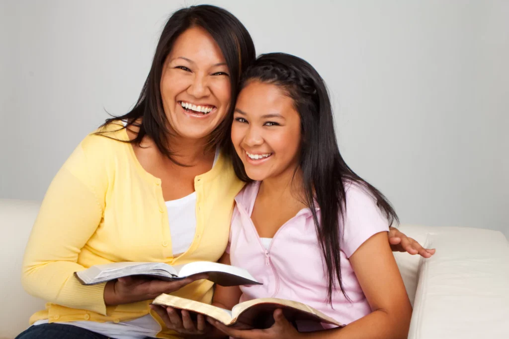 Mother and daughter reading the Bible together as part of raising godly teen disciples through intentional faith practices
