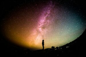 This image shows a person standing under a colorful array of stars. What does the Bible say about astrology?